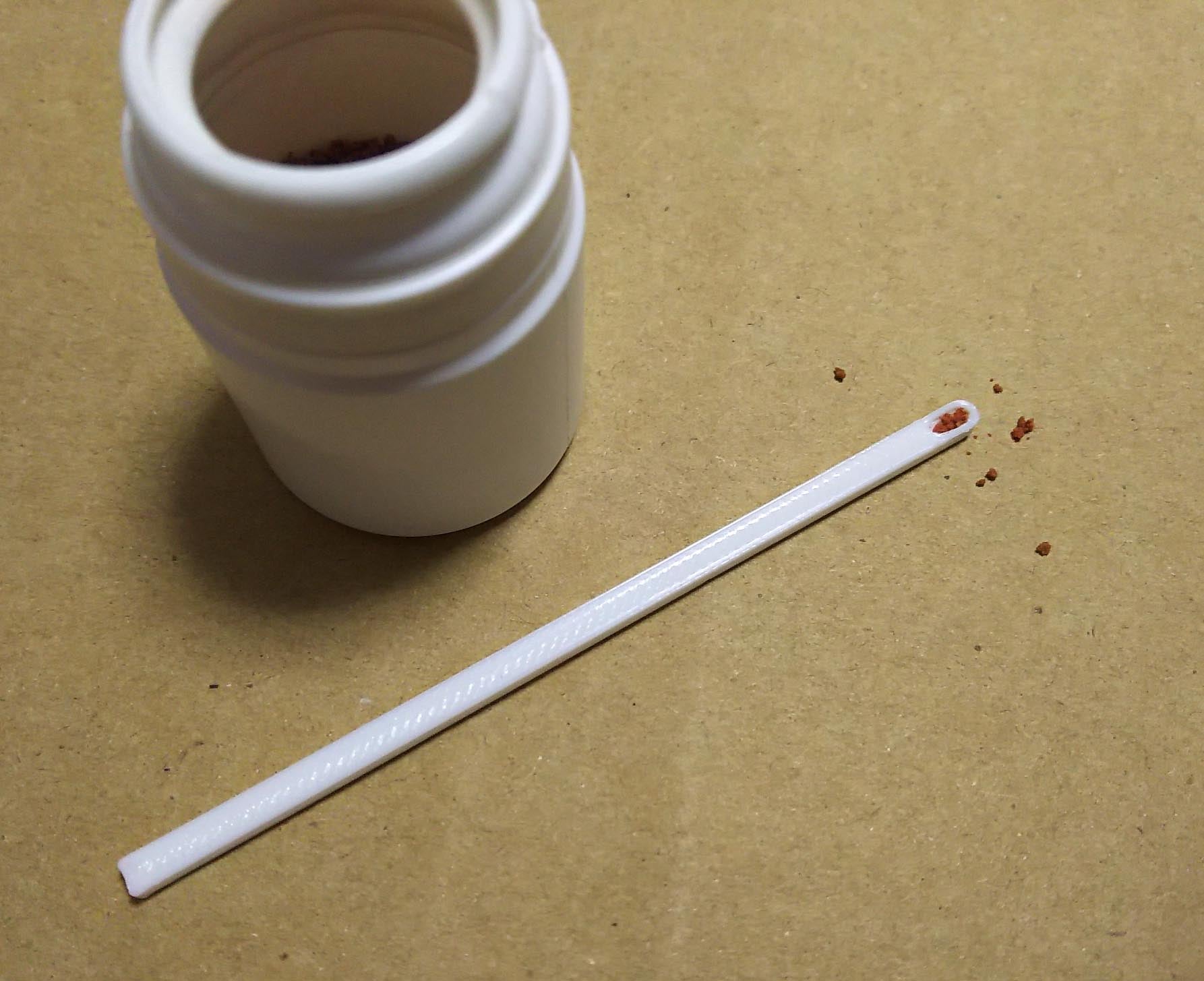 Tiny fish food spoon