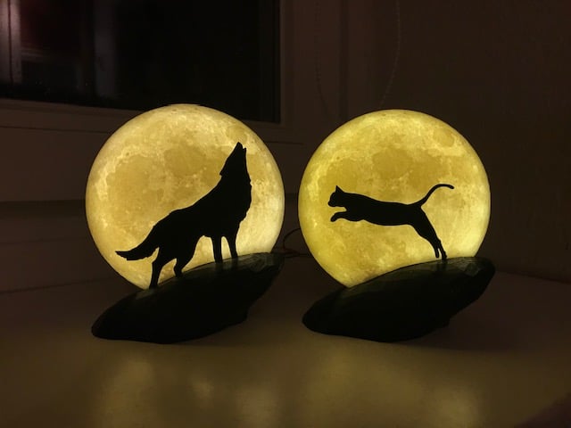 Wolf howling at the Moon