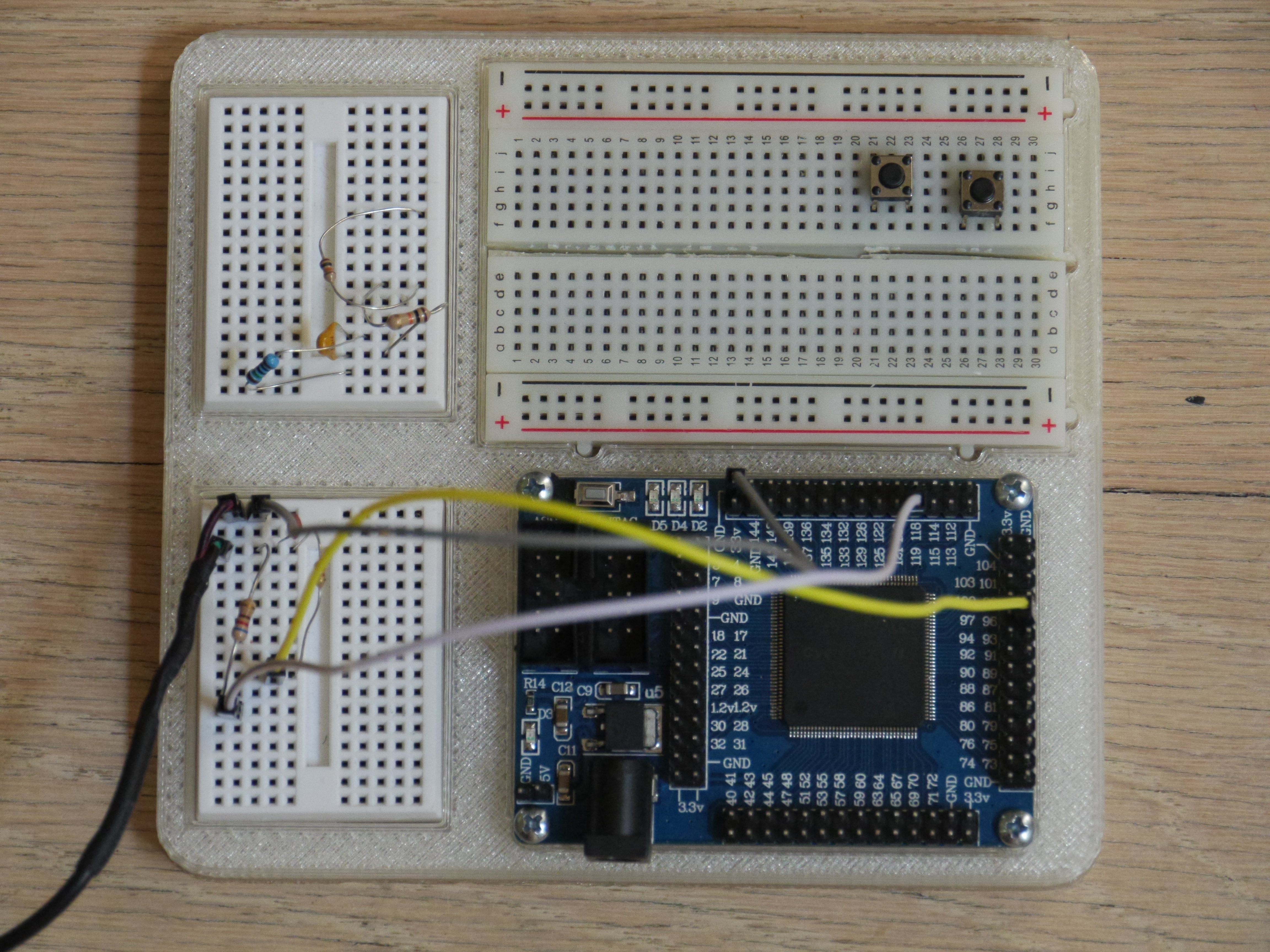 Cyclone II FPGA minimal development system and breadboard holder