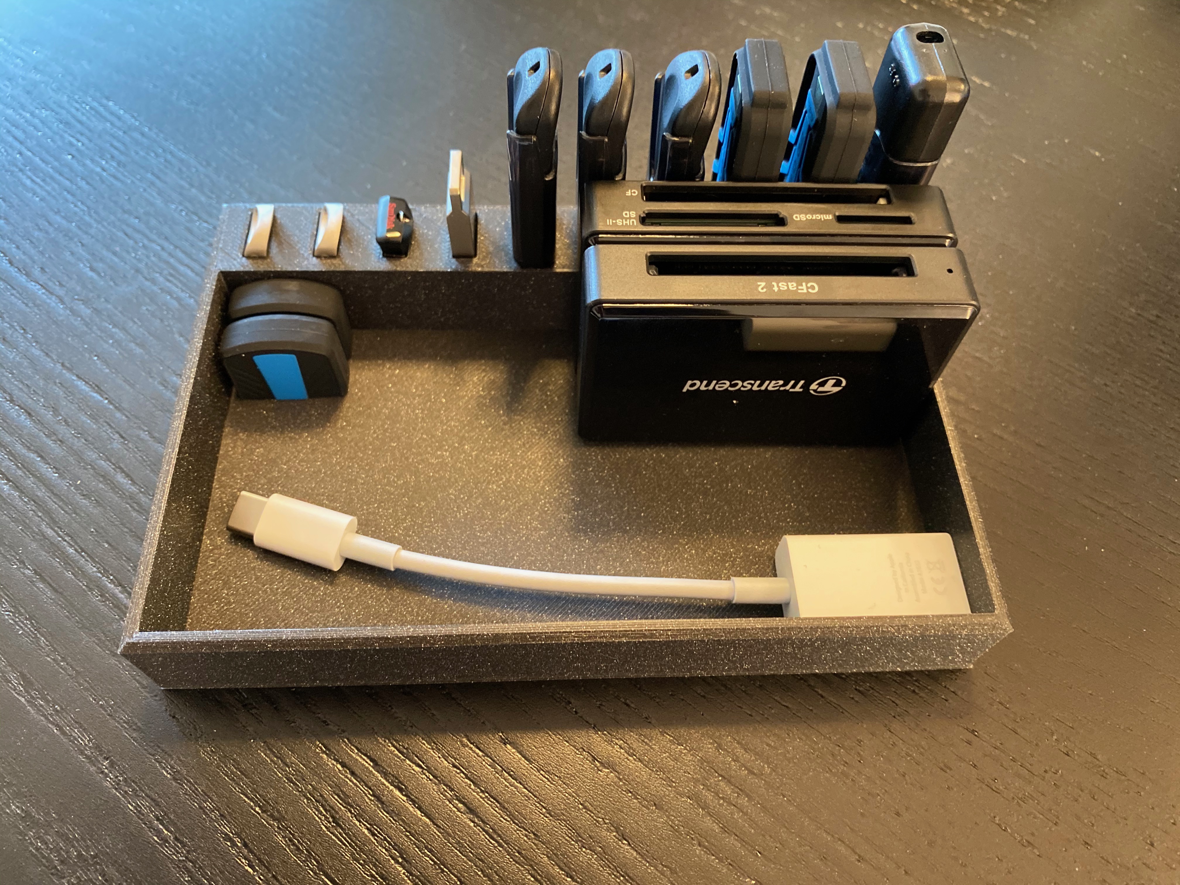 USB stick storage holder with extra space for caps and other equipment