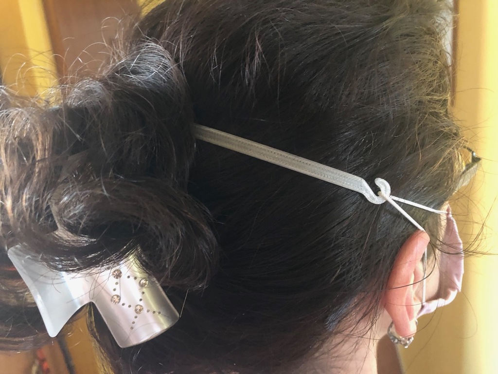 Face mask strap tension reliever