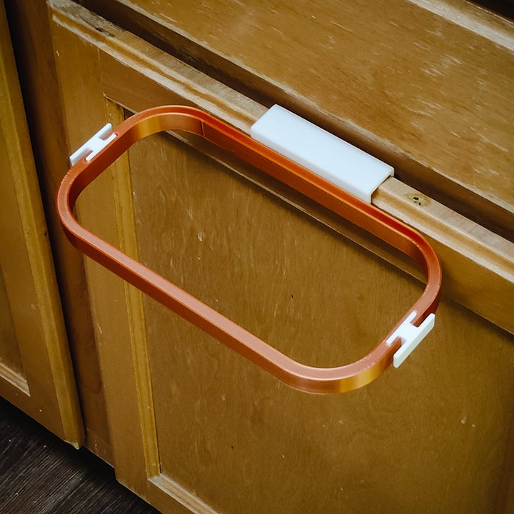 Trash bag holder for cabinet door