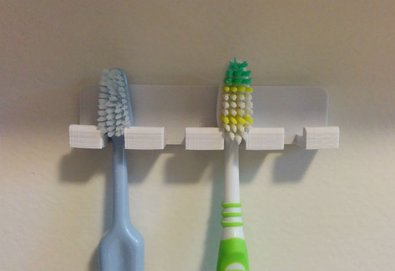 Wall-mounted toothbrush holder with rounded corners