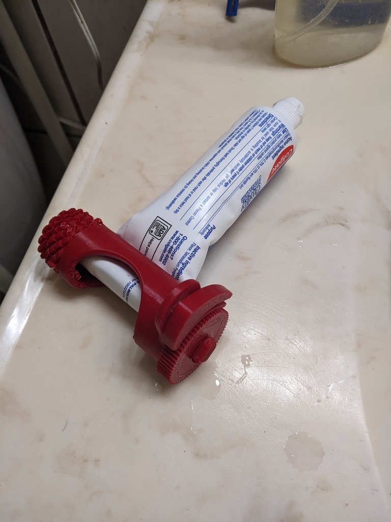 ratcheting toothpaste squeezer with release.