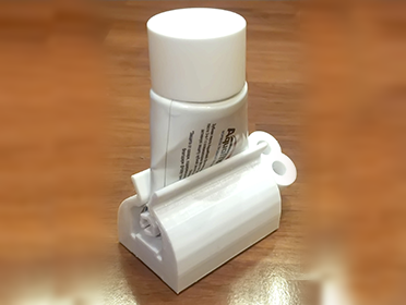 Toothpaste squeeze holder