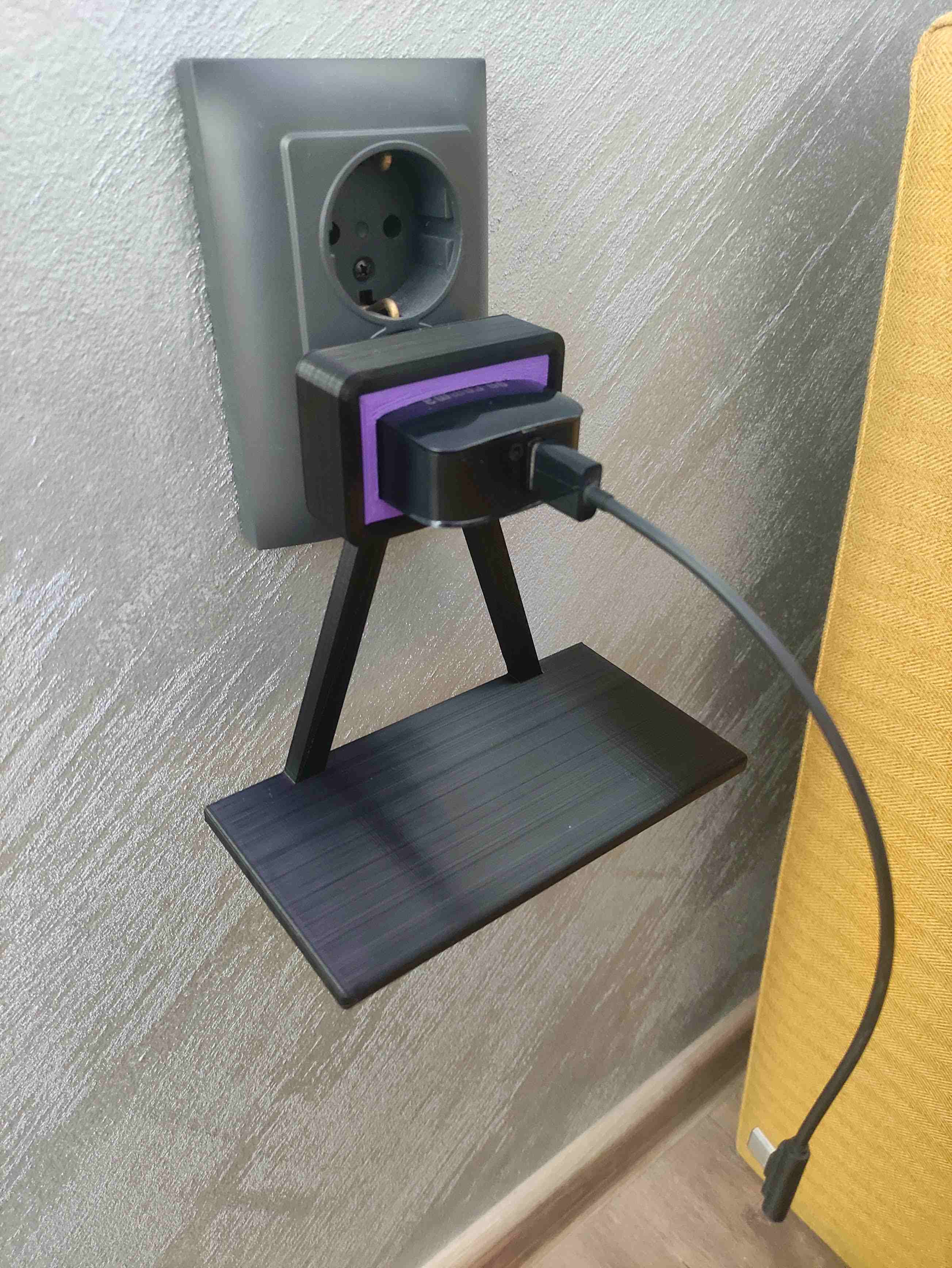 Wall outlet phone charging stand mounted over the charger
