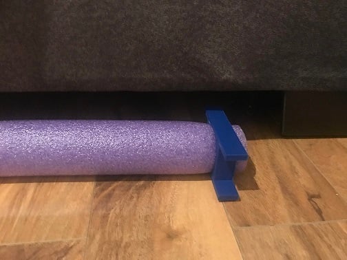 Pool Noodle Holder keeps pet toys from rolling under your couch.