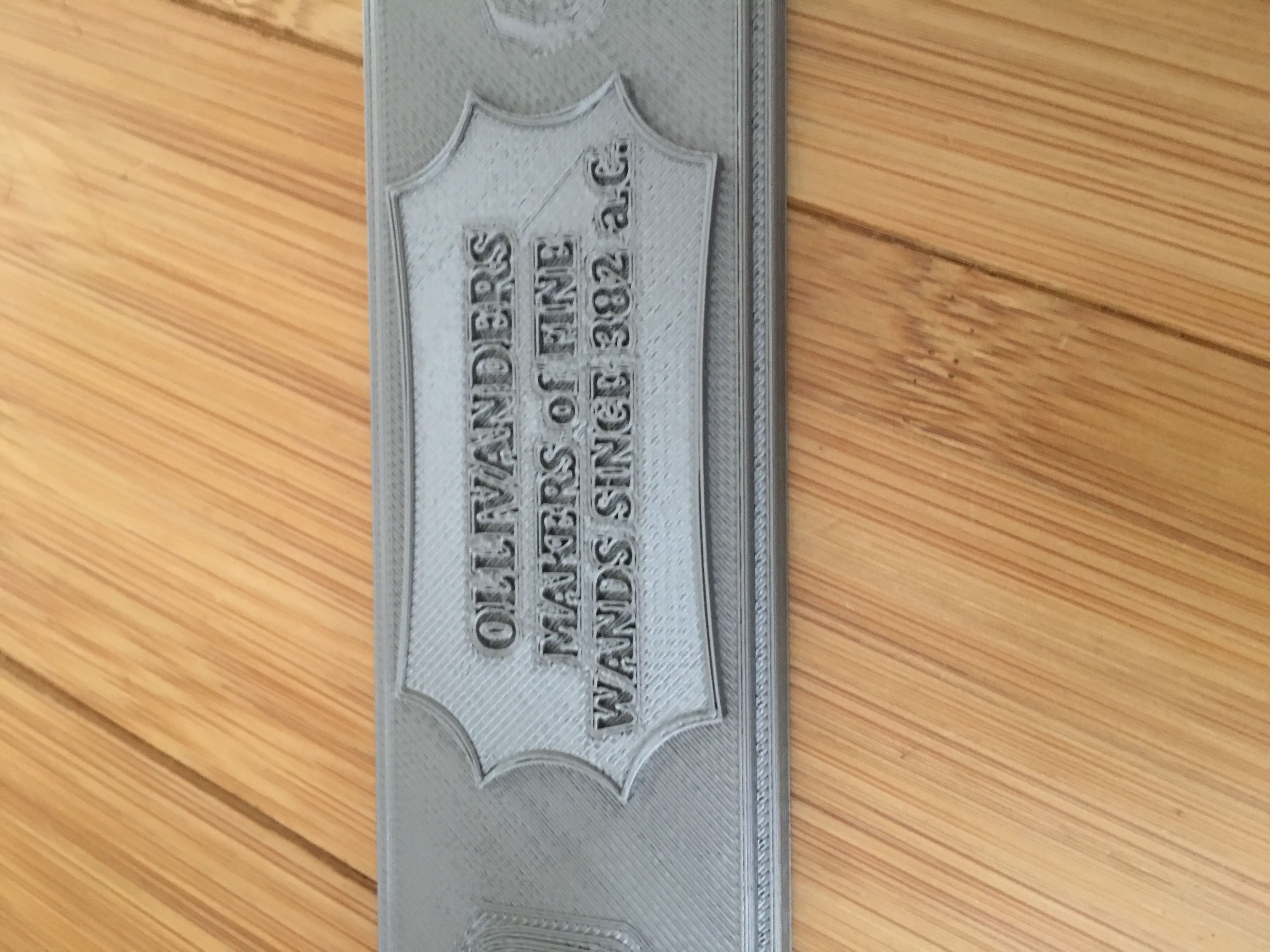 Wand stand with Ollivander's plaque