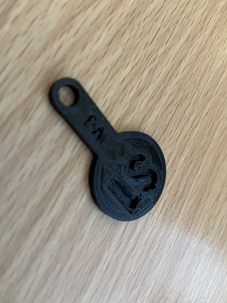 Australian $1 shopping trolley token with attachment hole