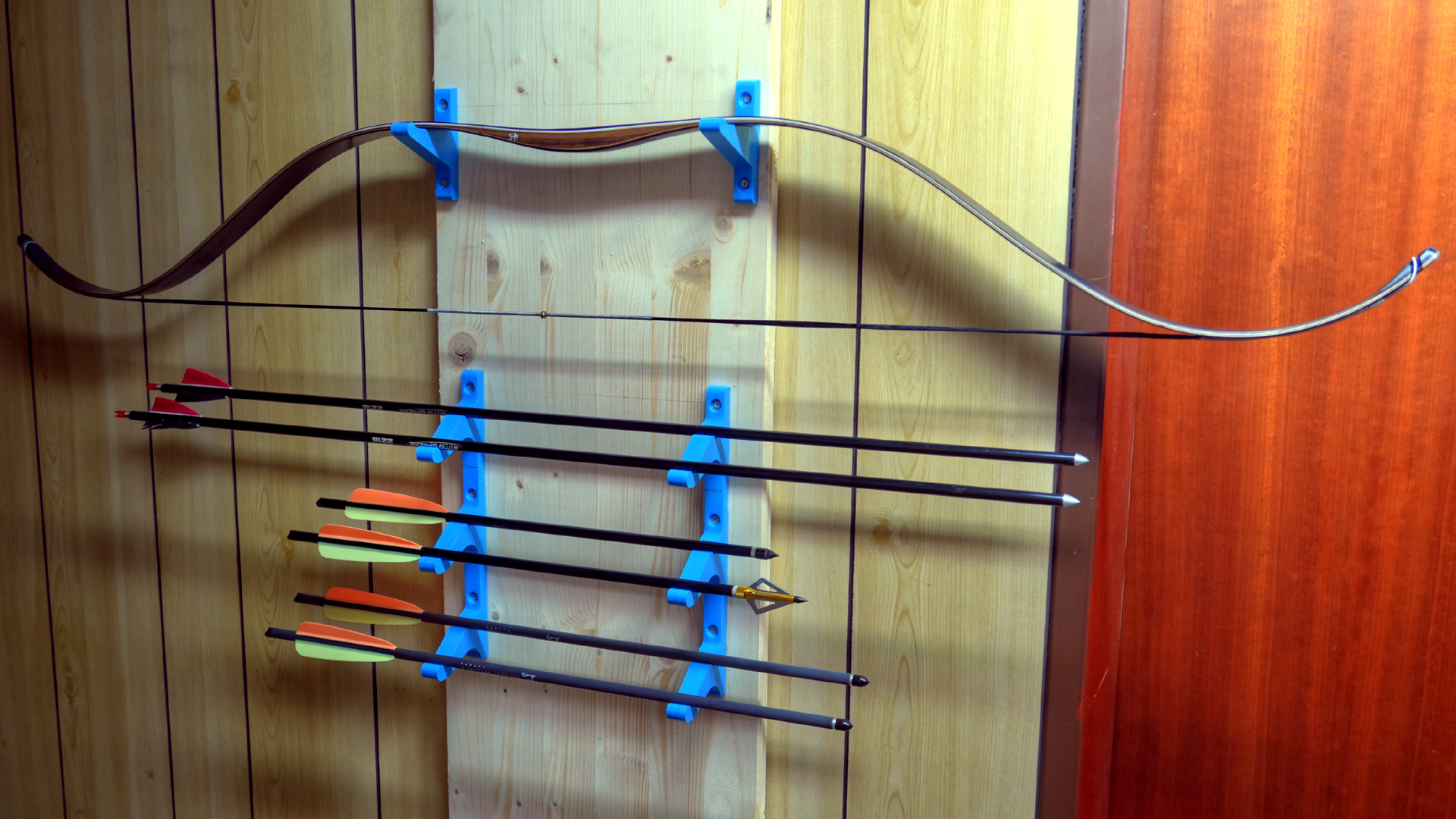 A narrow shelf / mount for a bow and six arrows
