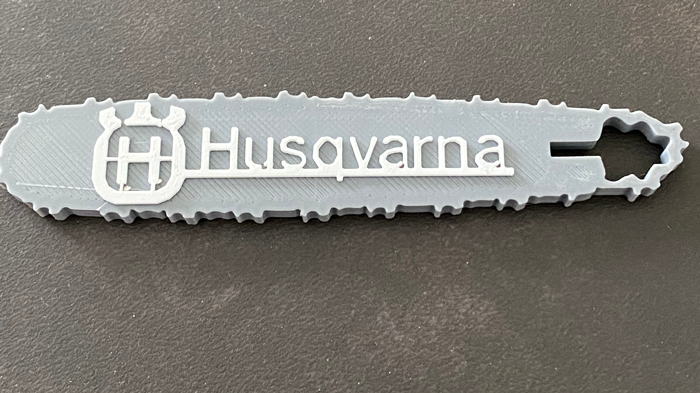 chain saw keychain with Husqvarna logo