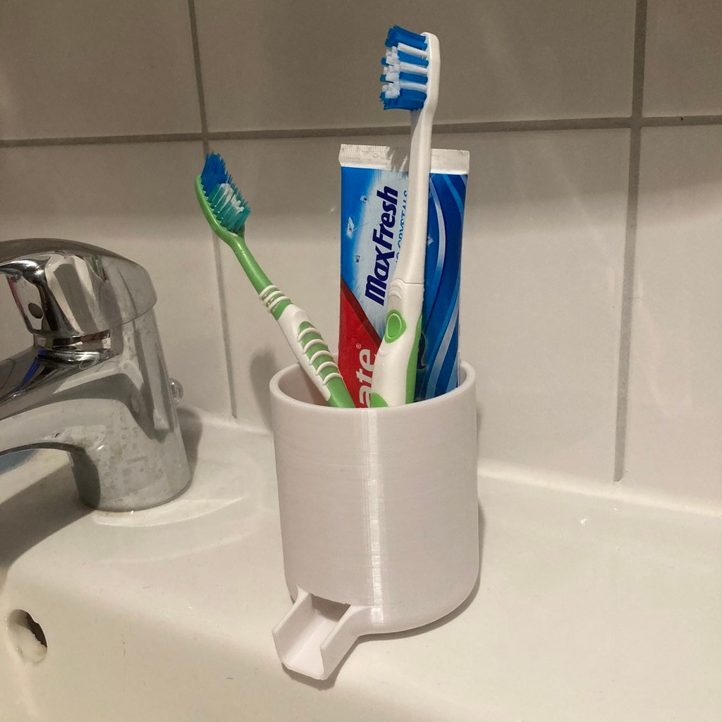Toothbrush holder with spout