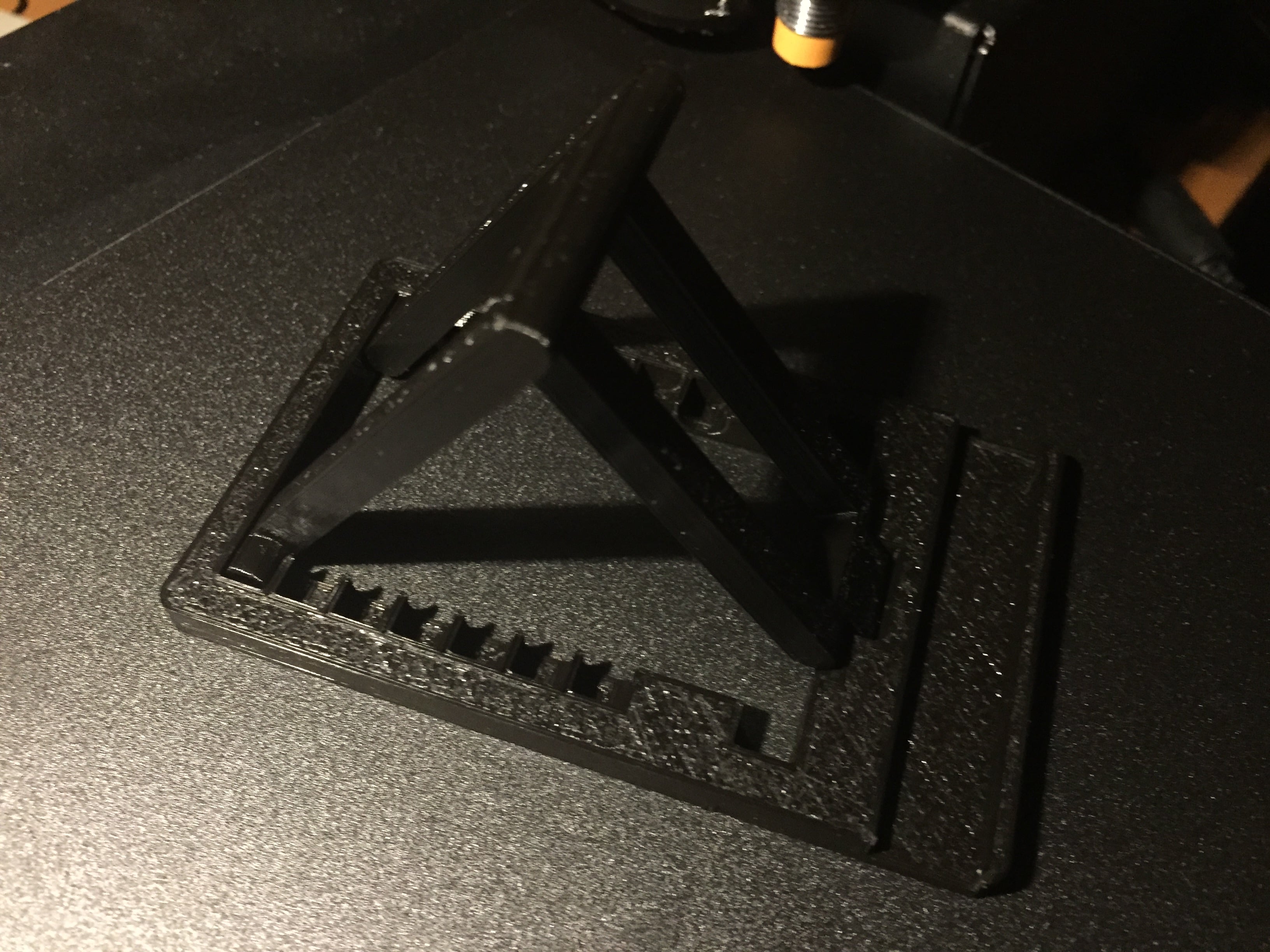 Universal phone/tablet stand with adjustable angle.