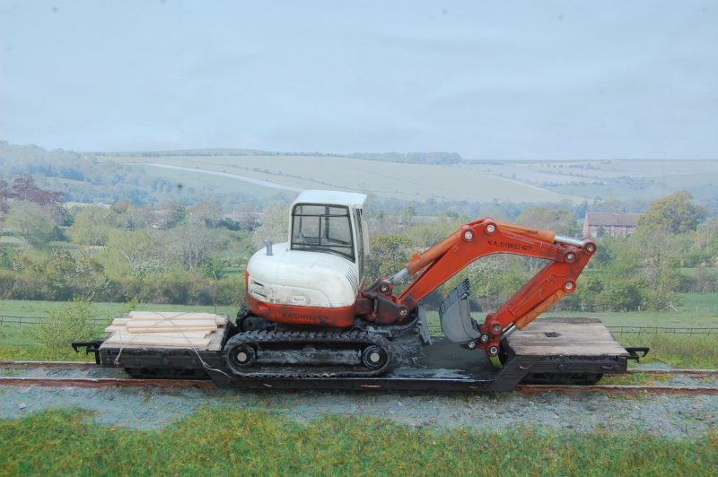 Bogie well wagon for carrying a mini digger.  0-16.5 model