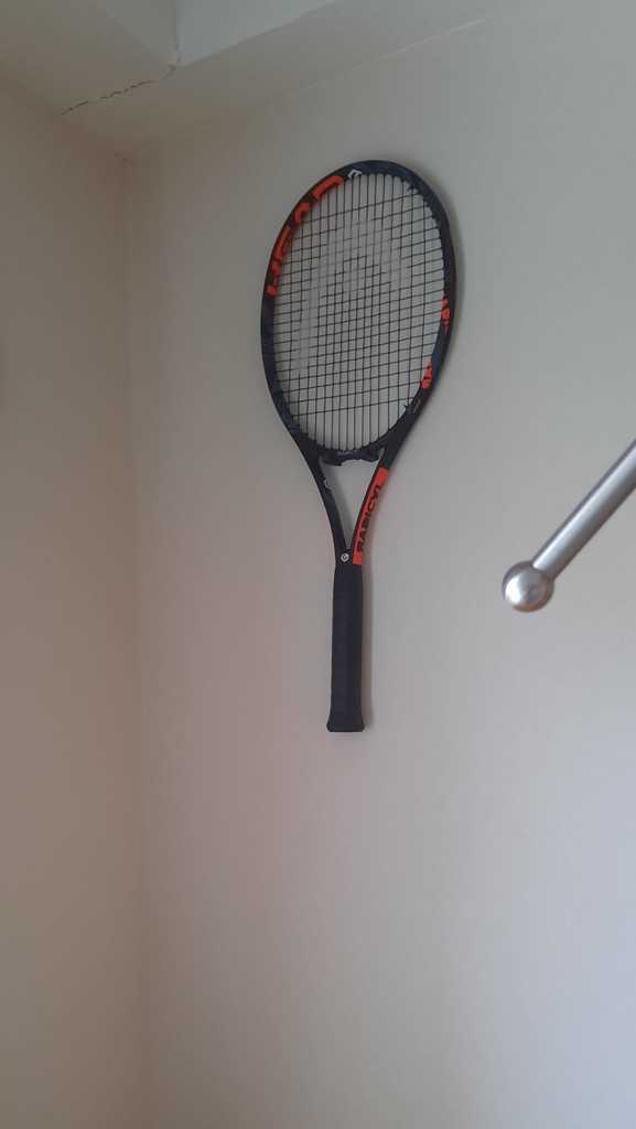 Tennis racket wall holder