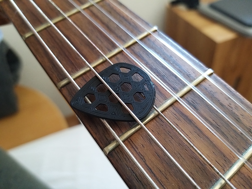 Guitar pick with hex-cutouts