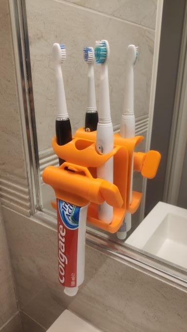 Toothpaste squeezer and toothbrush holder