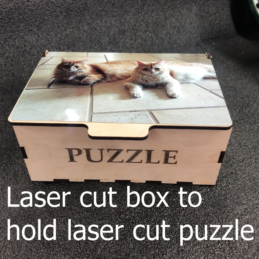 Laser cut box for laser cut puzzle