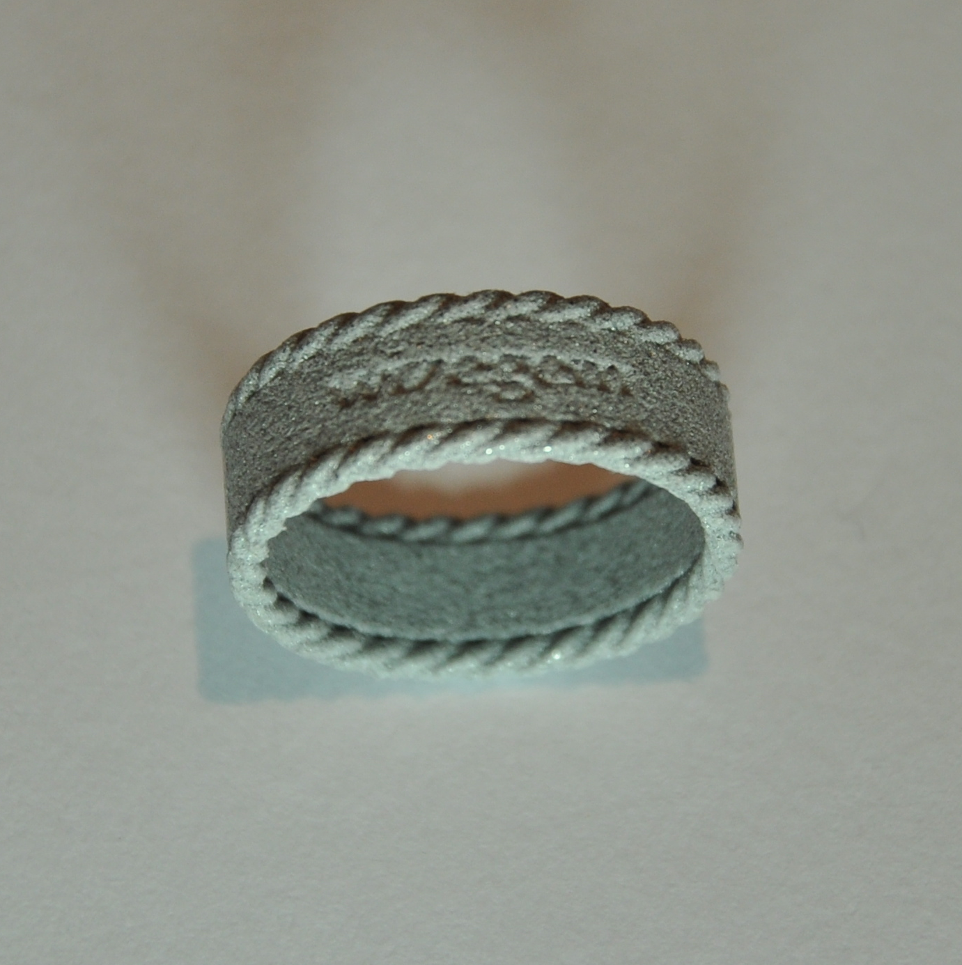 ring with text and rope decoration