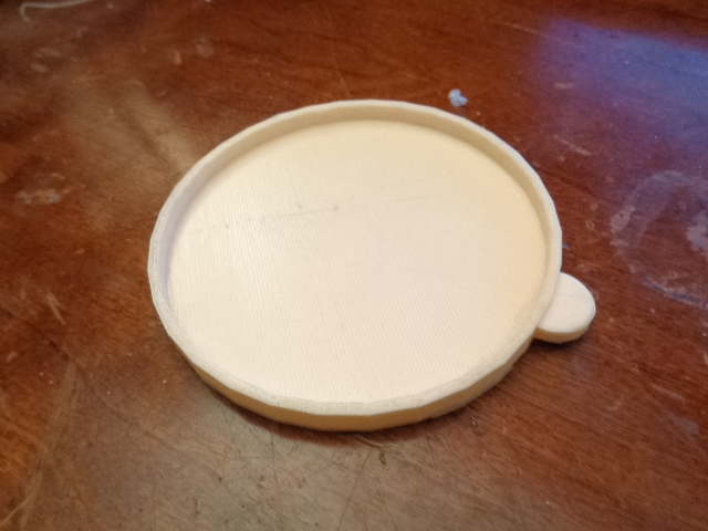 5.5 ounce cat food can lid.