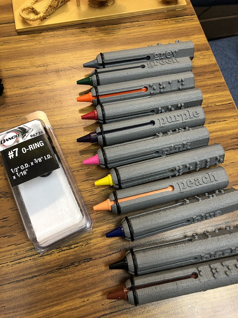 Crayon holders with braille and print