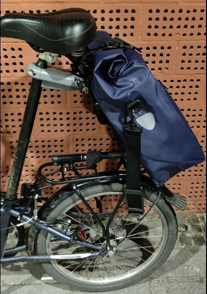 Folding bike, bike bag on carrier, adapter for leg buckle 