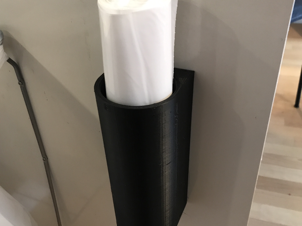Holder for a roll of garbage bags