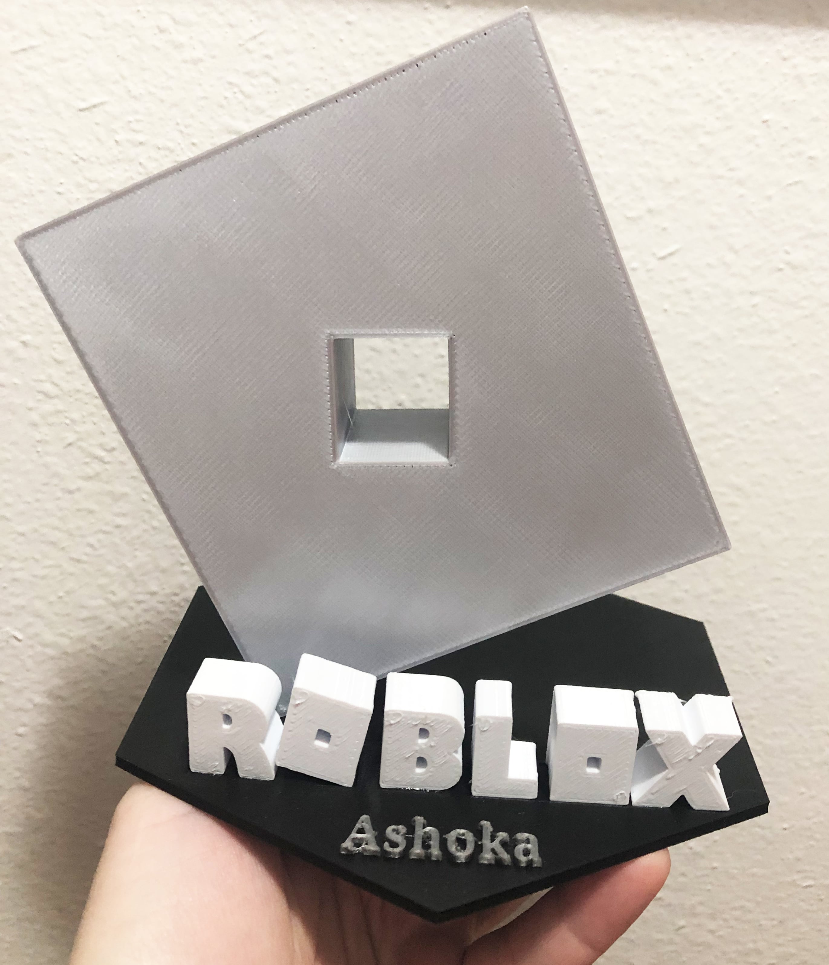 Roblox logo on stand