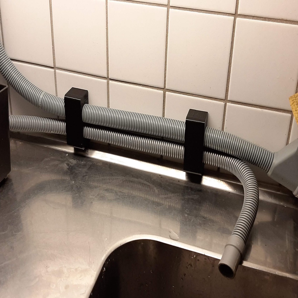 Dishwasher hose holder