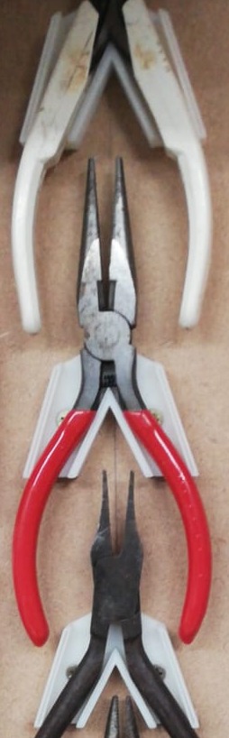 Wall holder for various types of small pliers and side cutters
