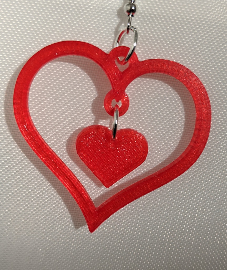 Heart earring outline with hanging solid heart