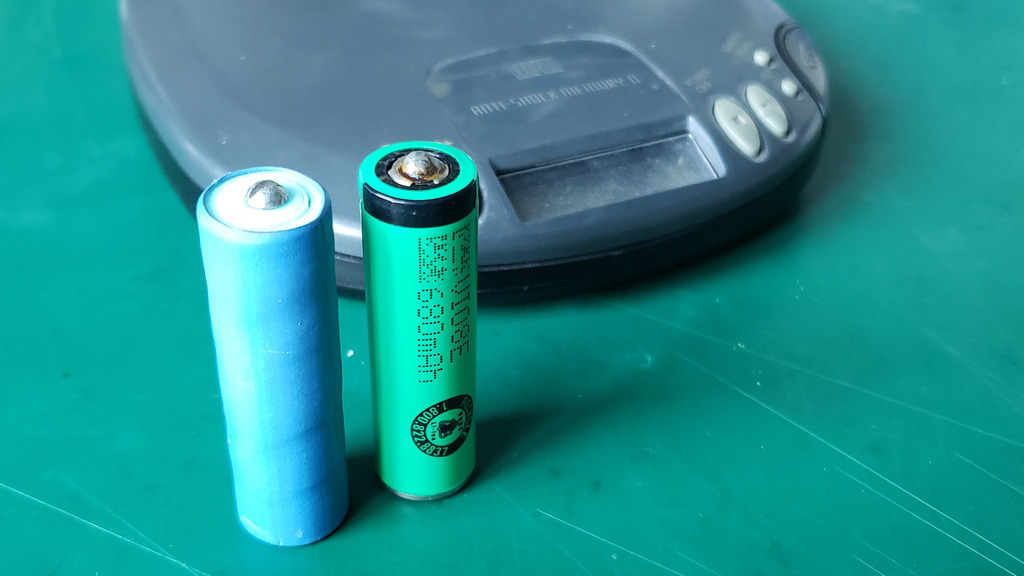 Fake batteries, used to allow AA lithium batteries to replace alkaline batteries.