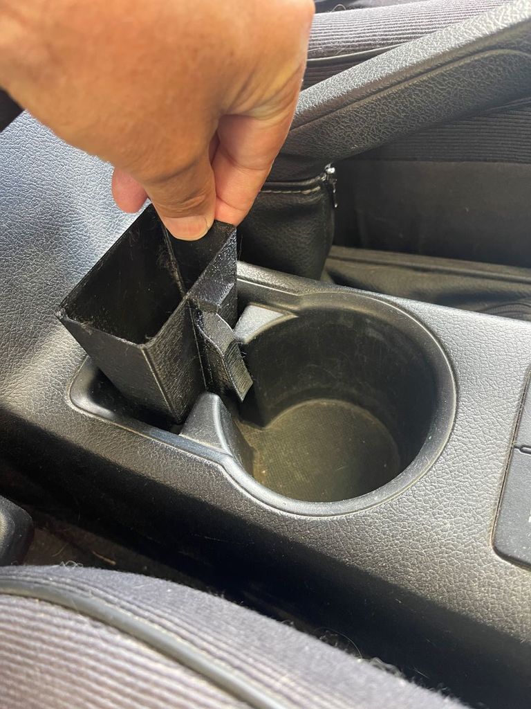 Coin holder for a Toyota Hilux pickup truck