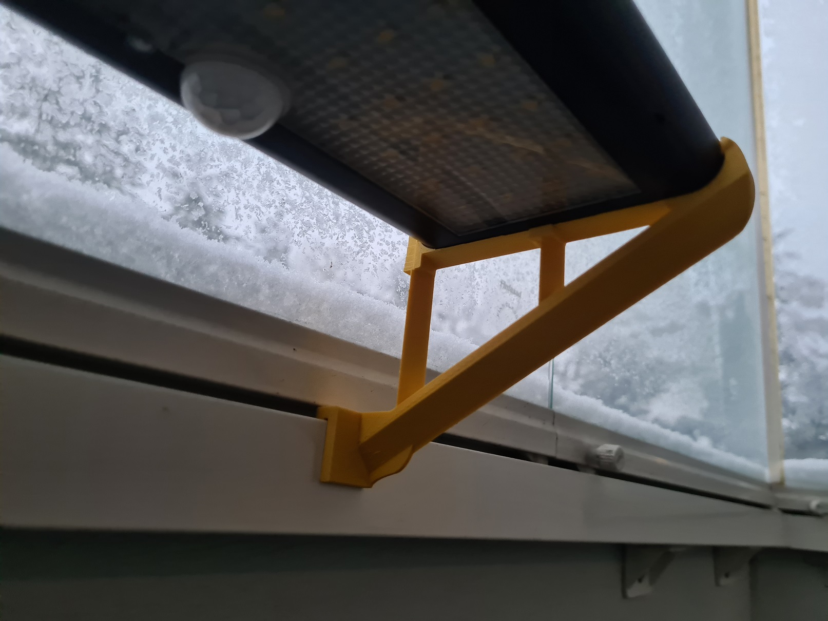 Balcony window frame holder for solar panel light