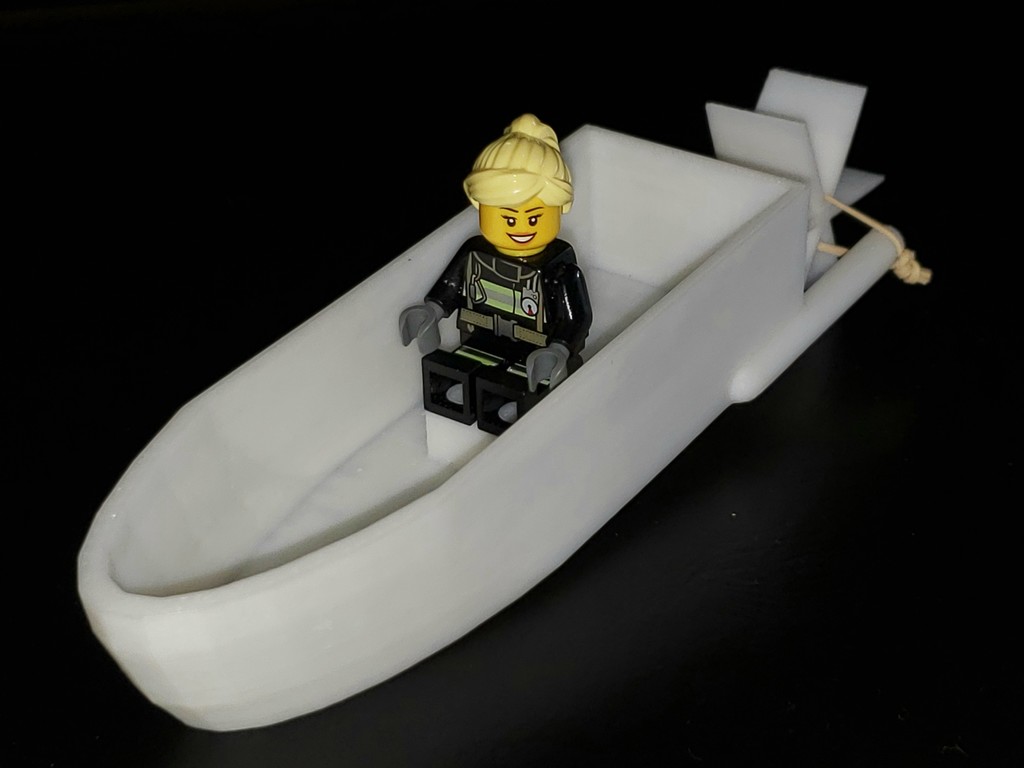 Rubber-band powered paddle boat with Lego seat