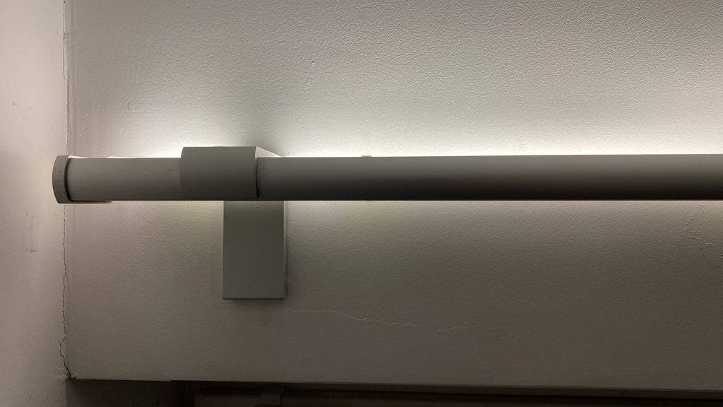 Customizable clip-on bracket for top-facing LED strips on curtain rails
