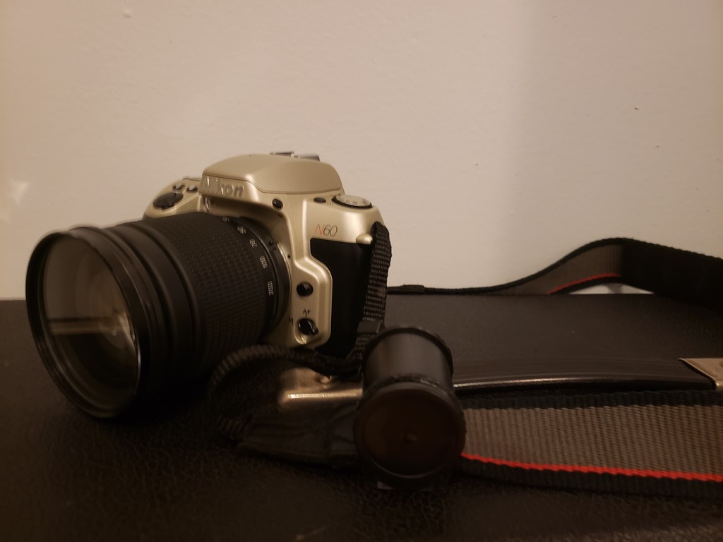 Camera strap film canister