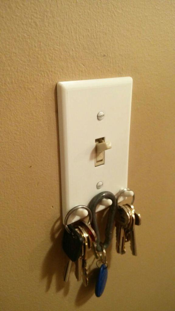 Light switch cover with key hooks