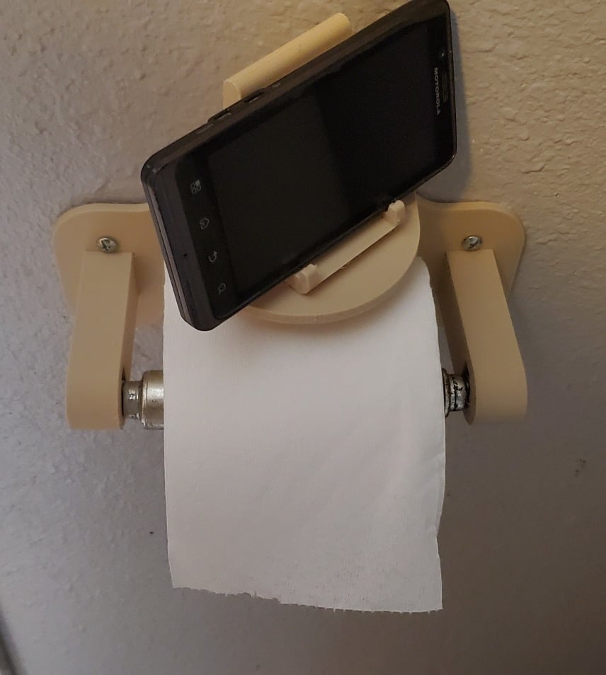 Toilet paper holder with rotating phone rest