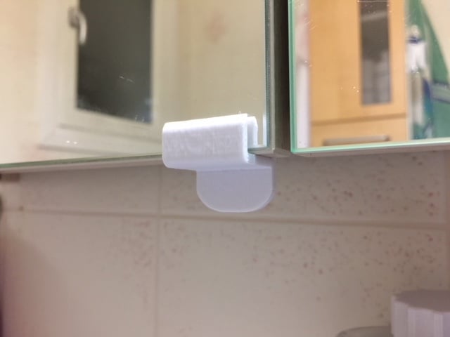 Mirror door handle on bathroom cabinet
