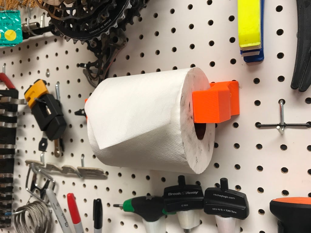 Pegboard holder for toilet paper roll