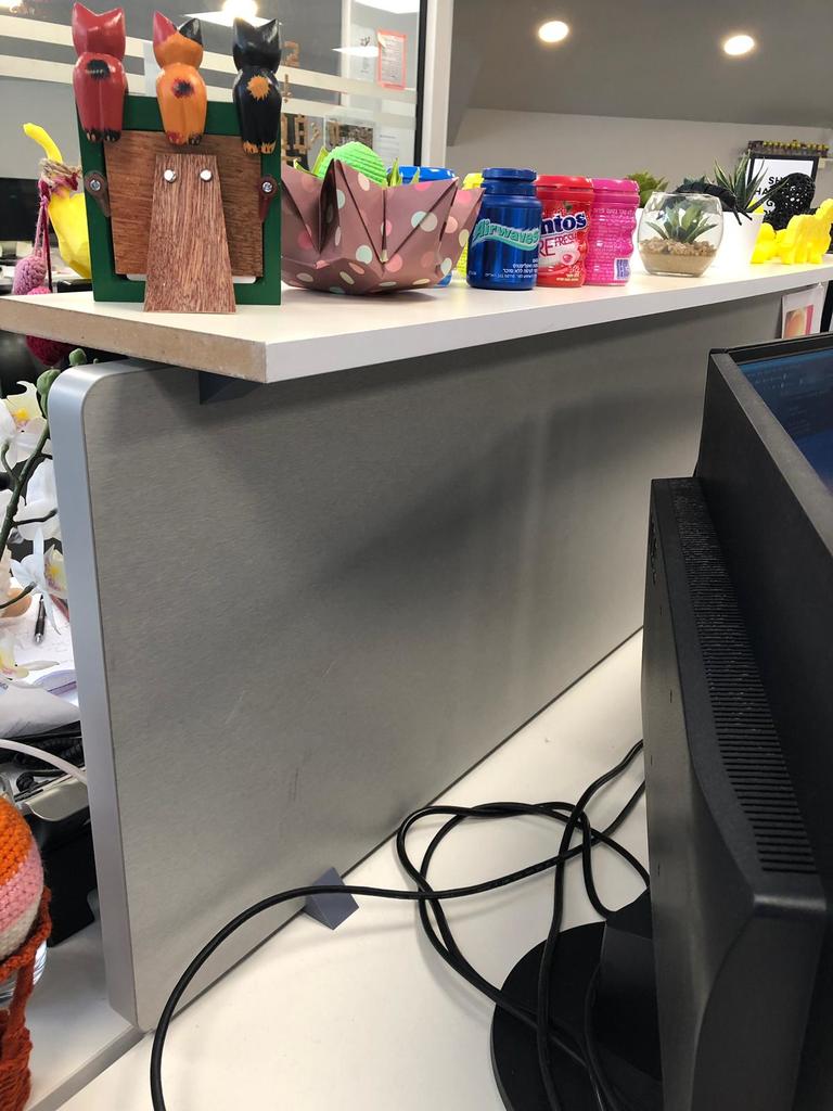 Shelf bracket on top of a cubicle partition