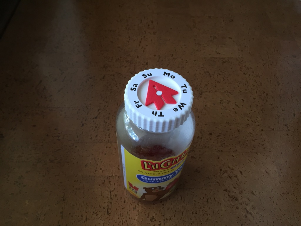 Vitamin bottle cap with day arrow