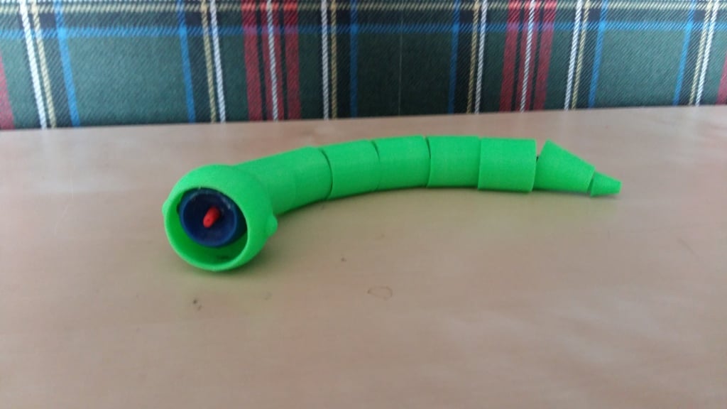 Big snake eats small snake toy