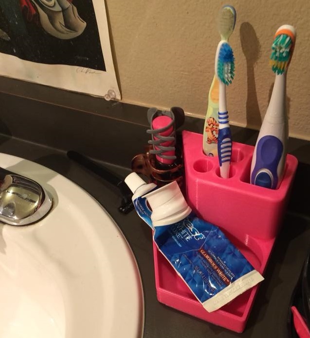 Toothbrush/hairclip/tooth-paste (and electric brush spot)/random holder for side of oval sink.