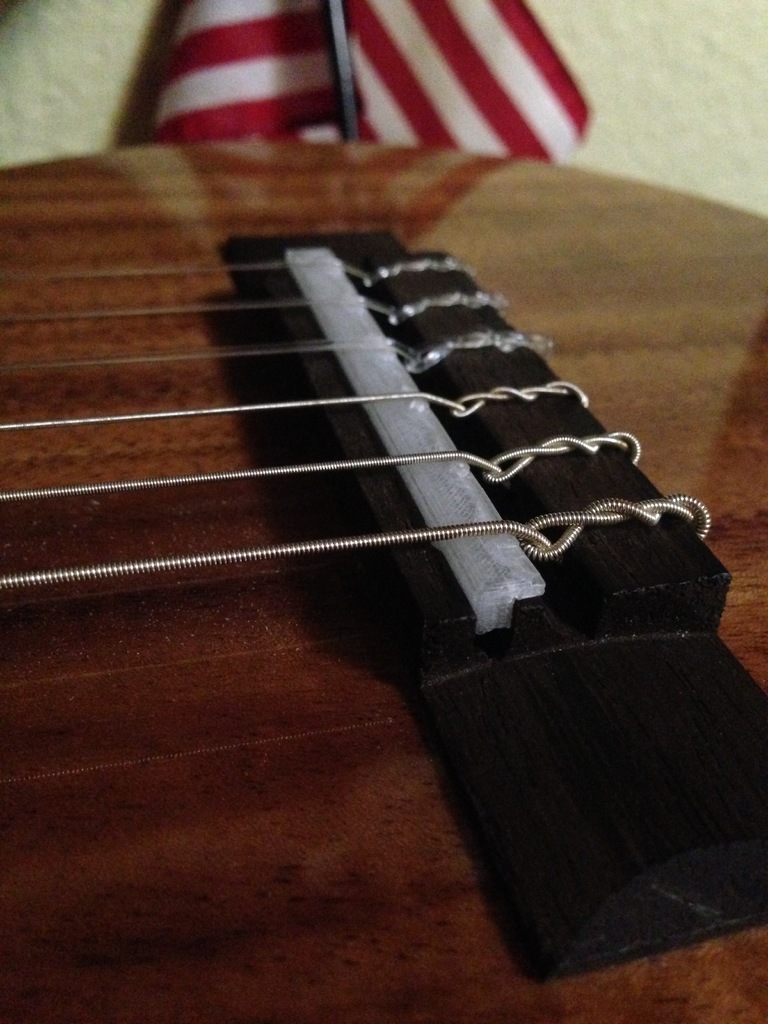 Guitar bridge to fix sharp intonation