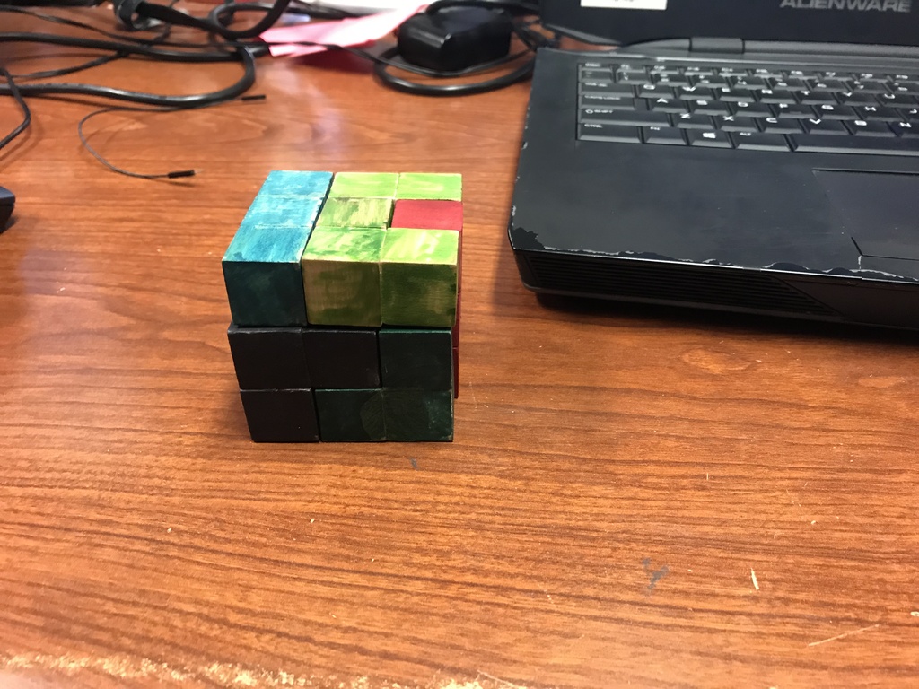 Puzzle cube assembled and the pieces