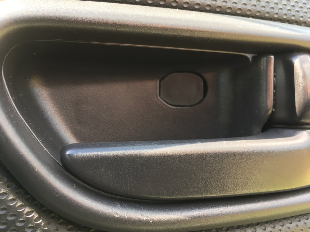 Subaru Forester SG (2002 - 8) door release lever screw cover.