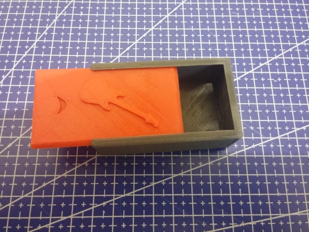 small slide box with a guitar