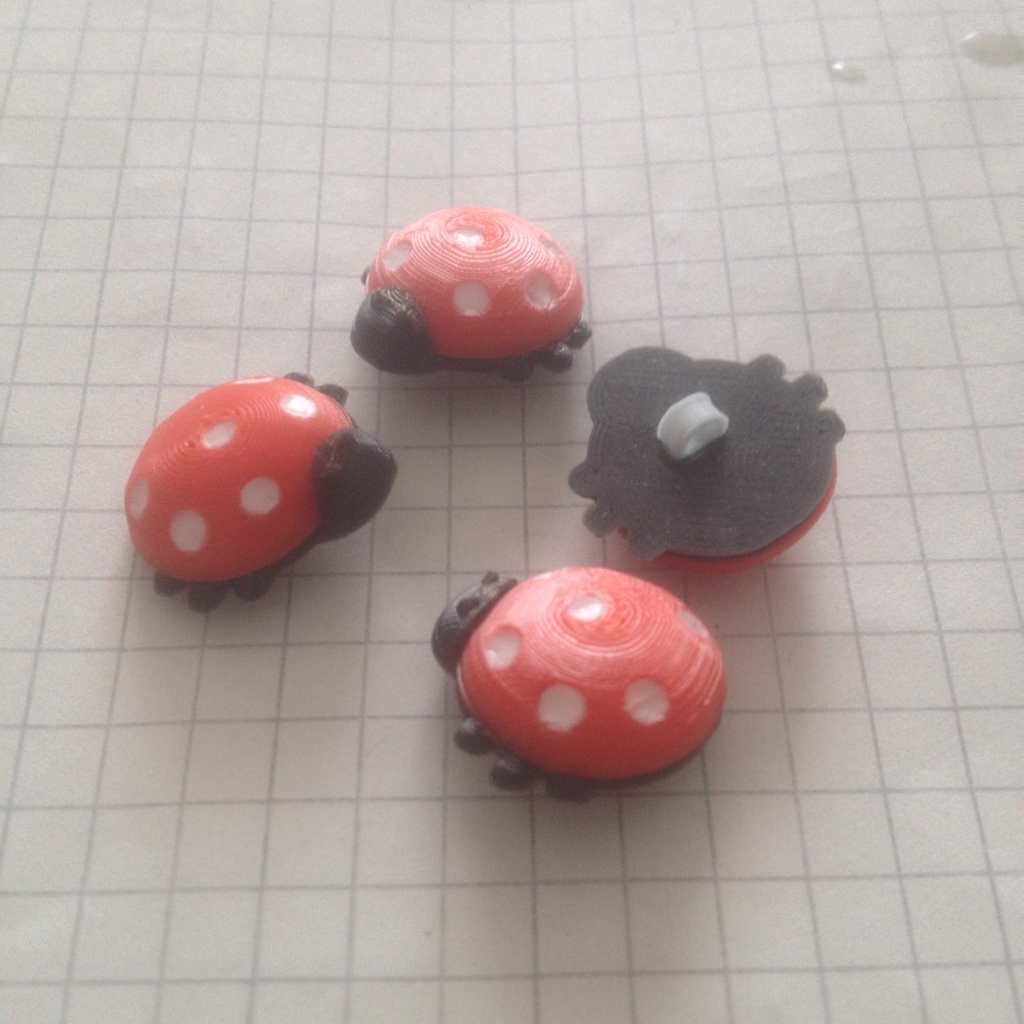 Children's buttons in the shape of ladybugs.